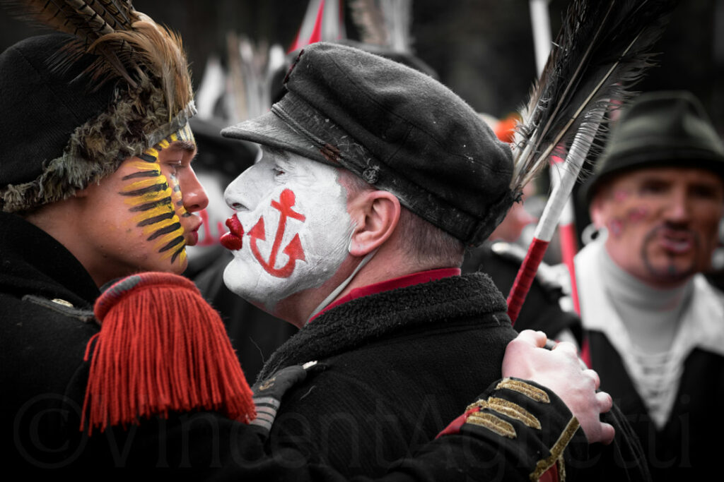 Personnages déguisés pendant le carnaval de Dunkerque, pratiquant un zotche, c'est a dire un baiser sur la bouche en guise de bonjour.