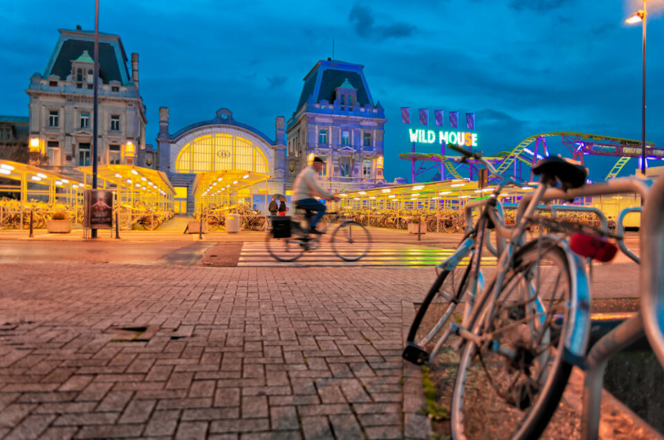 Gare d’Ostende à l’heure bleue avec vélos et fête foraine en Belgique