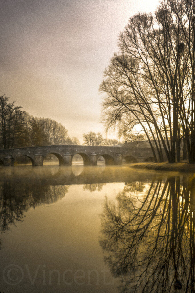 Pont de pierre sur l’Ouche en Bourgogne avec arbres reflétés dans l’eau